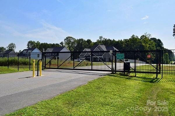 view of gate with a yard