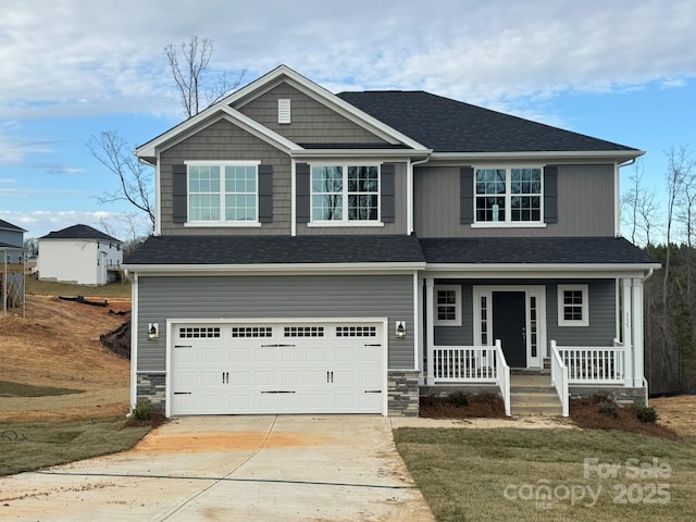 craftsman house featuring a garage and a front lawn