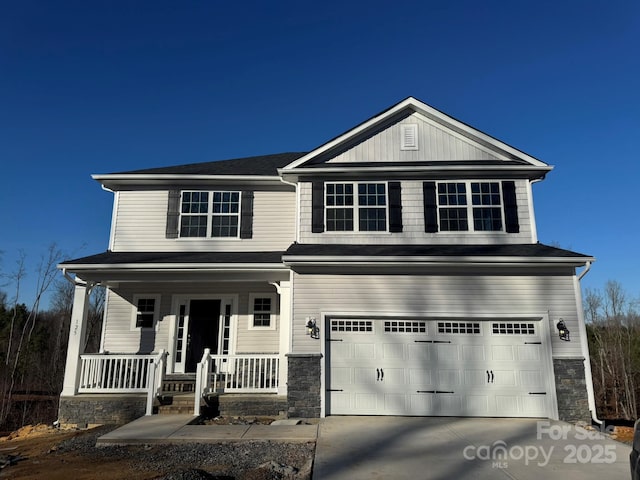 view of front of property featuring covered porch and a garage