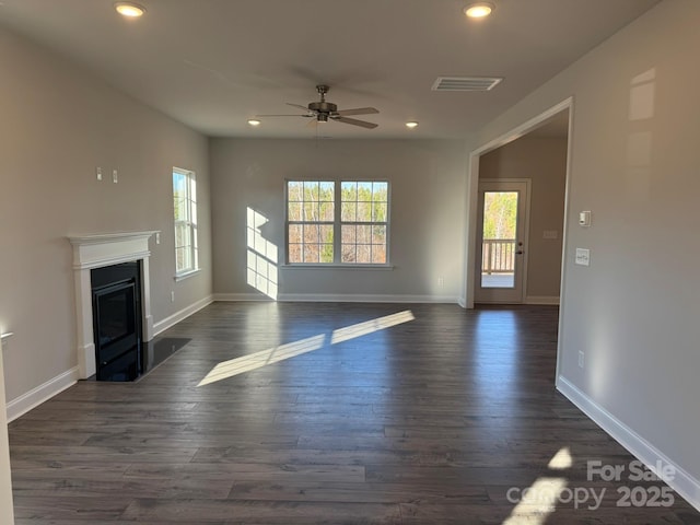 unfurnished living room with ceiling fan and dark hardwood / wood-style flooring