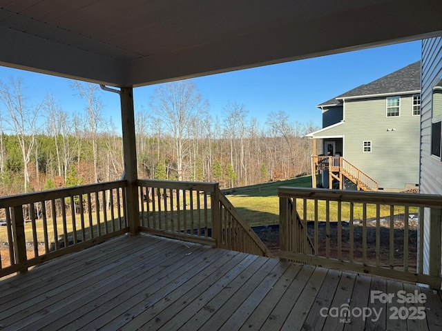 wooden terrace with a yard