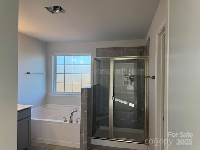 bathroom featuring tile patterned flooring, vanity, and separate shower and tub