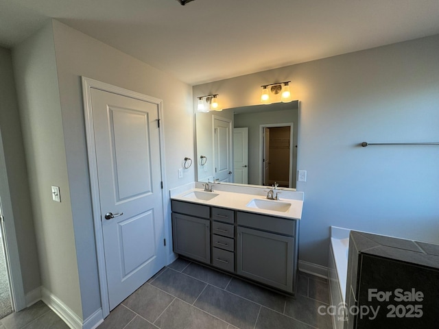 bathroom featuring tile patterned flooring, vanity, and a bathtub