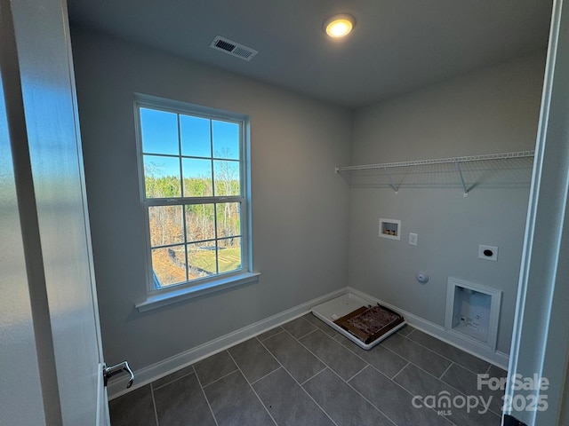 washroom with hookup for an electric dryer, washer hookup, hookup for a gas dryer, and dark tile patterned flooring