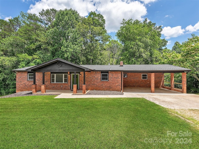 ranch-style house with a front yard and a carport