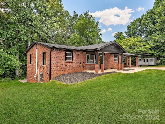 exterior space featuring a front yard and a patio