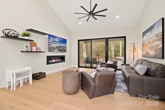 living room with high vaulted ceiling and light hardwood / wood-style floors