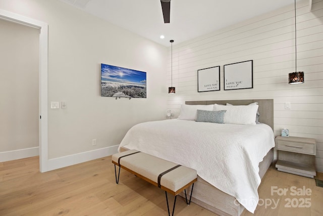 bedroom featuring ceiling fan and light hardwood / wood-style flooring