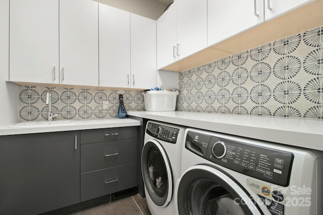 laundry area featuring cabinets and washer and clothes dryer