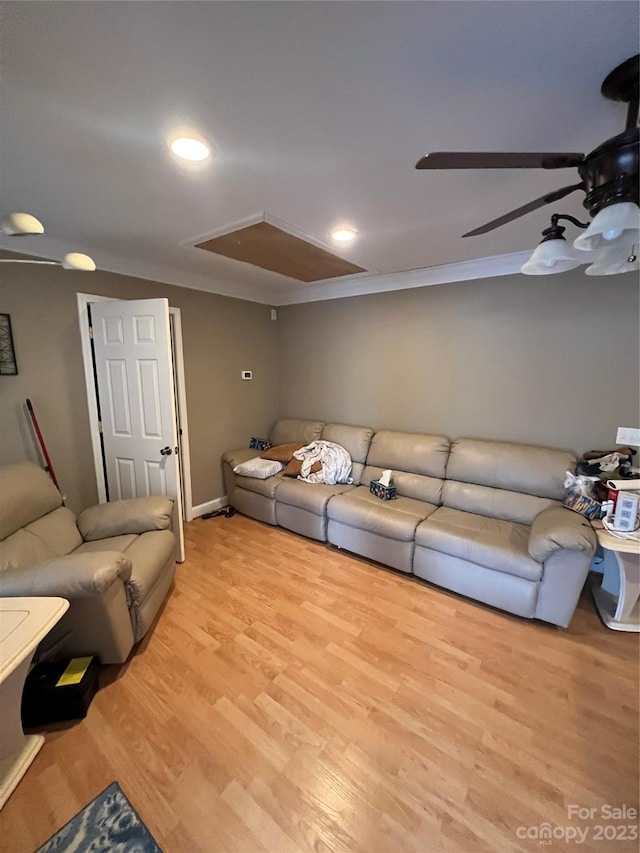 living room featuring ceiling fan, light wood-type flooring, and ornamental molding