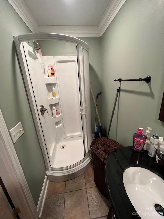 bathroom with a shower with door, ornamental molding, and tile floors