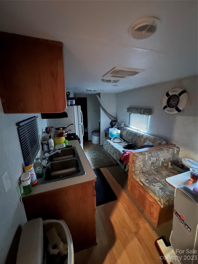 kitchen with hardwood / wood-style floors and sink