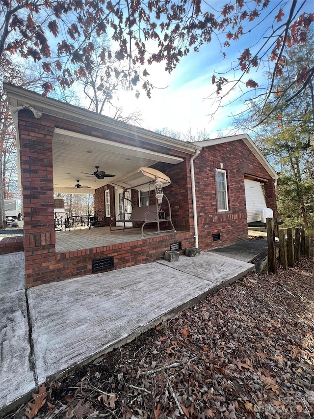 back of property featuring a patio, ceiling fan, and a garage