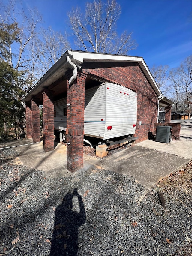 view of side of home with central AC