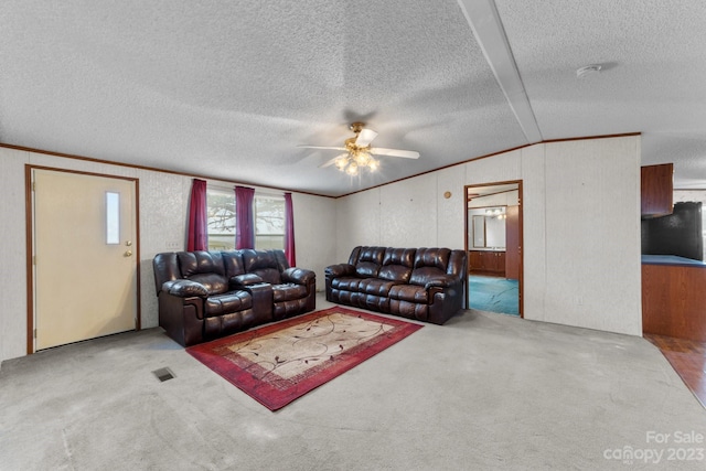 carpeted living room with ceiling fan, lofted ceiling, and a textured ceiling