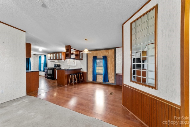 unfurnished dining area featuring a textured ceiling, dark tile floors, and sink