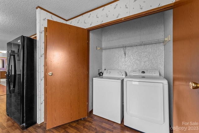 laundry area featuring washer and clothes dryer, dark hardwood / wood-style floors, hookup for a washing machine, and a textured ceiling