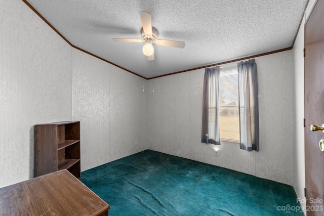 carpeted empty room with ceiling fan, a textured ceiling, and crown molding