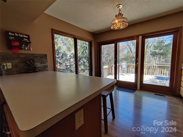 dining area featuring light hardwood / wood-style flooring and a textured ceiling