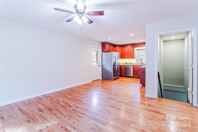 kitchen featuring appliances with stainless steel finishes, light hardwood / wood-style floors, and a healthy amount of sunlight