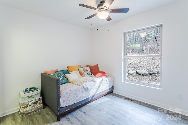 bedroom with dark hardwood / wood-style flooring and ceiling fan