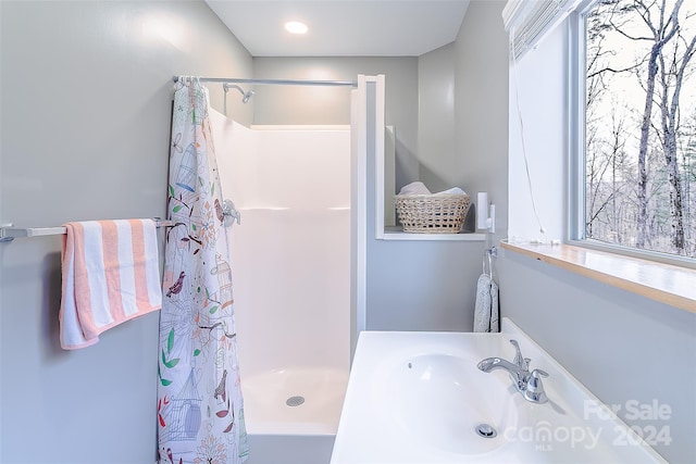 bathroom with sink and curtained shower