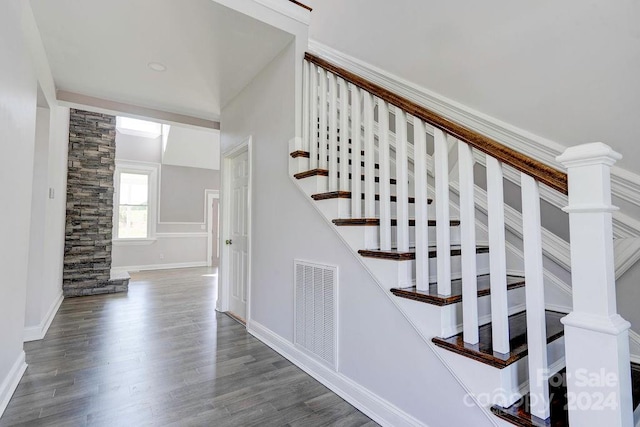 stairway with dark hardwood / wood-style flooring