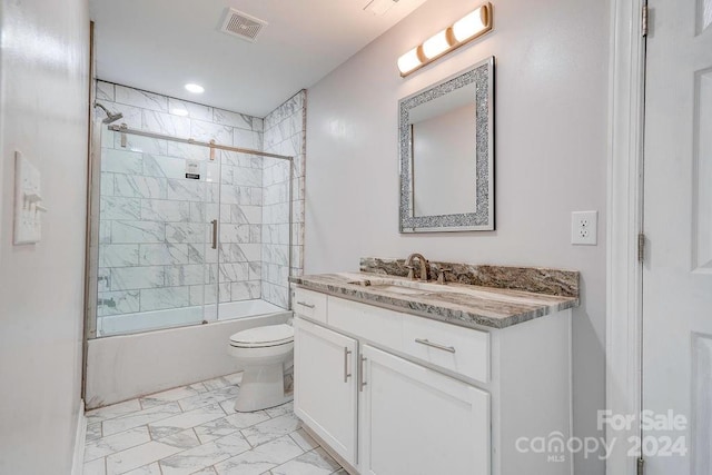 full bathroom with enclosed tub / shower combo, vanity, toilet, and tile floors