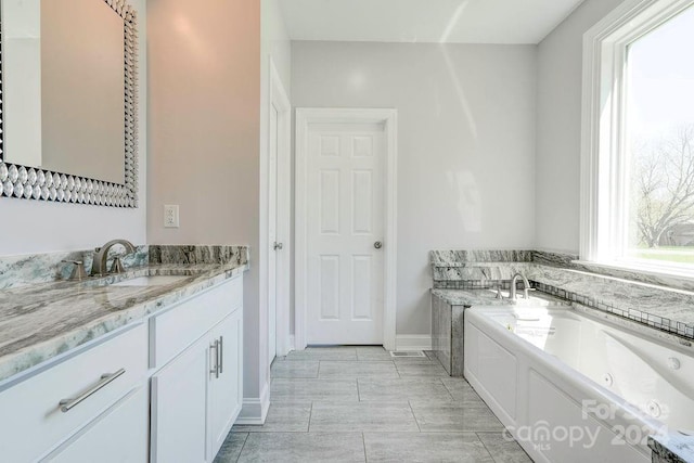 bathroom featuring tile flooring, vanity, and a tub