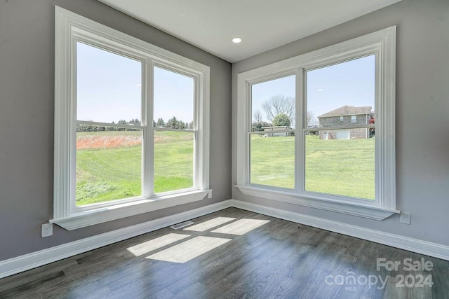 spare room featuring dark hardwood / wood-style flooring