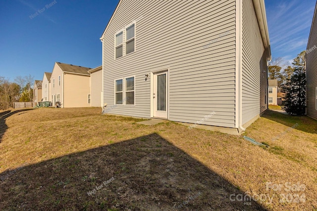 back of property featuring a lawn