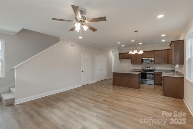 kitchen with crown molding, sink, a center island, and stainless steel appliances