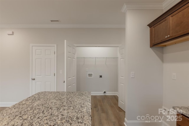 laundry room featuring hookup for an electric dryer, crown molding, hookup for a washing machine, and light hardwood / wood-style flooring