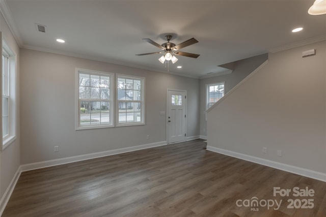 entryway featuring ceiling fan, dark wood-type flooring, and ornamental molding