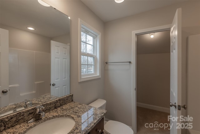 bathroom featuring vanity and toilet