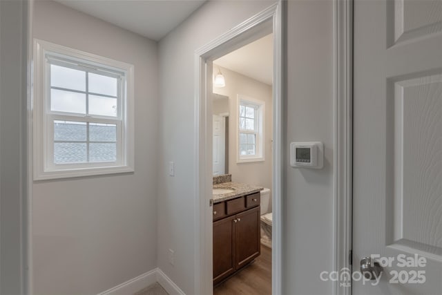 bathroom with vanity, hardwood / wood-style flooring, toilet, and a wealth of natural light