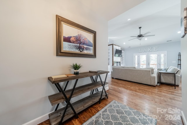 hallway featuring light hardwood / wood-style floors and french doors