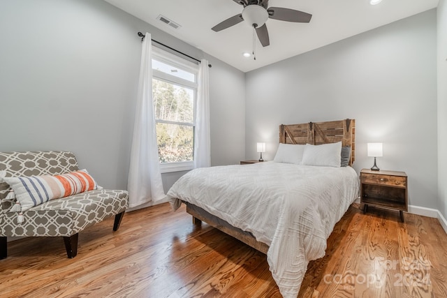 bedroom with light hardwood / wood-style floors and ceiling fan