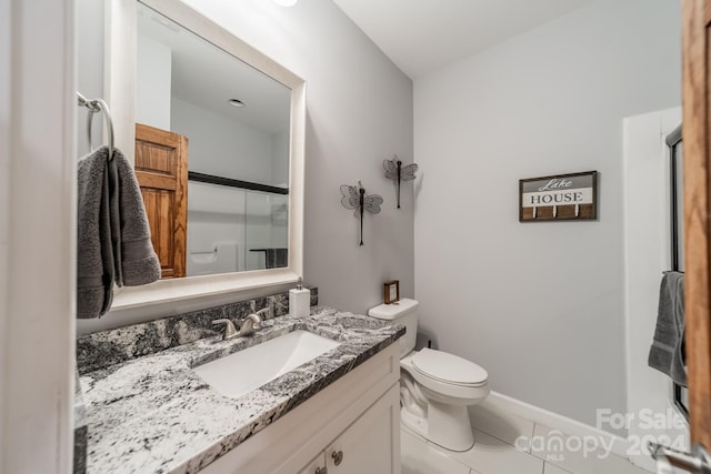 bathroom featuring tile flooring, toilet, and vanity