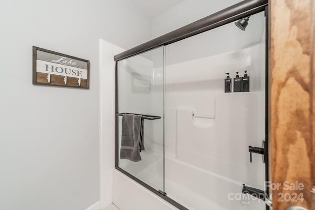 bathroom featuring shower / bath combination with glass door