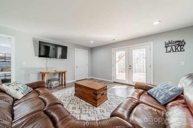 living room with light hardwood / wood-style floors and french doors