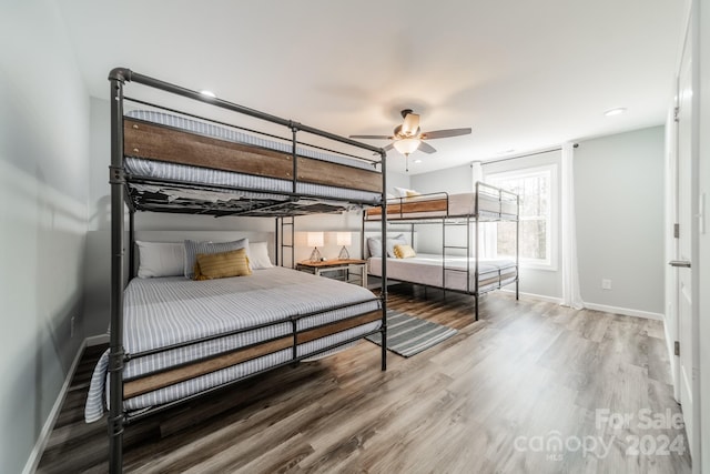 bedroom with ceiling fan and wood-type flooring