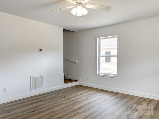 spare room featuring hardwood / wood-style flooring and ceiling fan