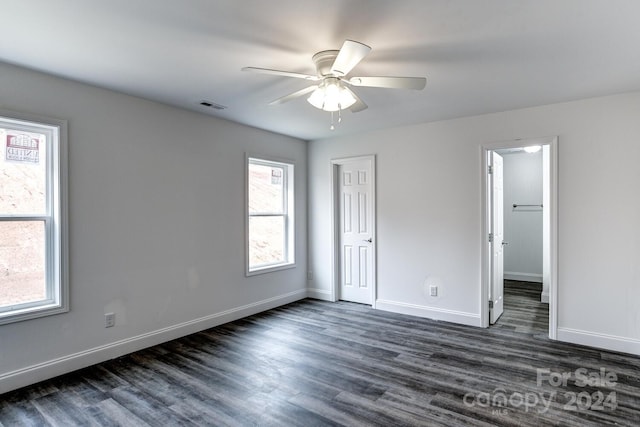 unfurnished room with ceiling fan and dark hardwood / wood-style flooring