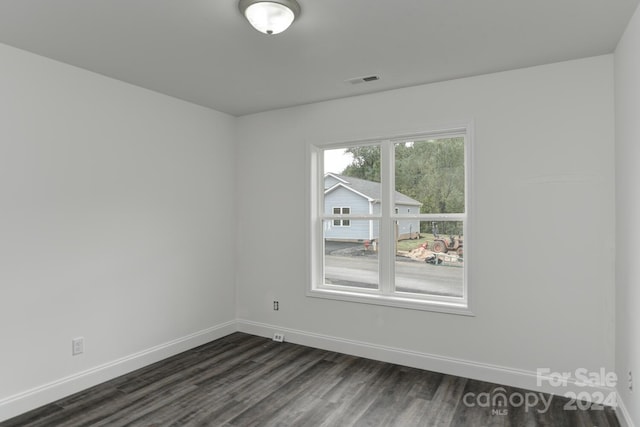 empty room featuring dark wood-type flooring