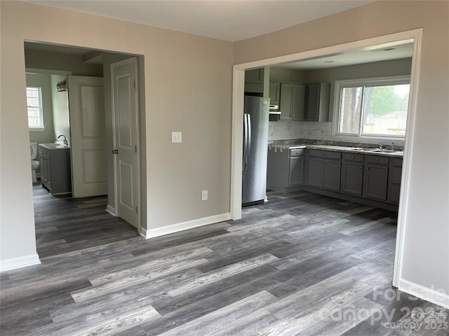 kitchen featuring tasteful backsplash, stainless steel refrigerator, and dark hardwood / wood-style flooring