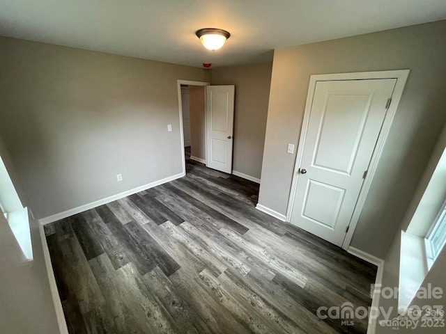 unfurnished room featuring dark hardwood / wood-style flooring