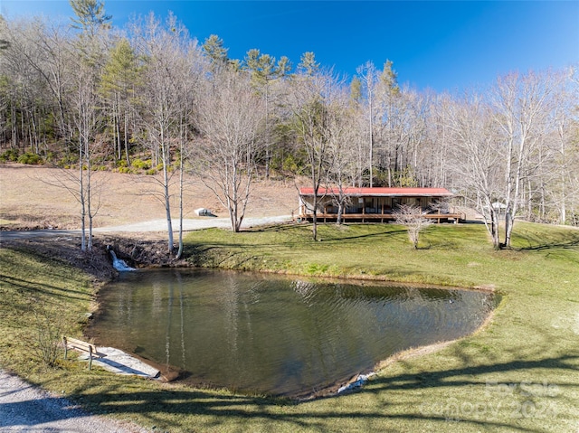 exterior space featuring a water view and a lawn