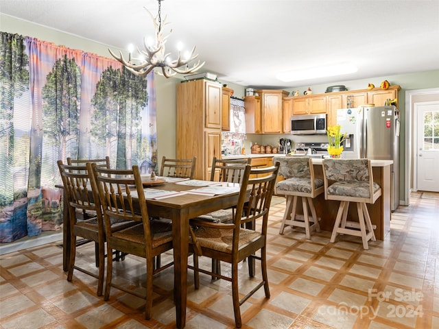 tiled dining space featuring a chandelier