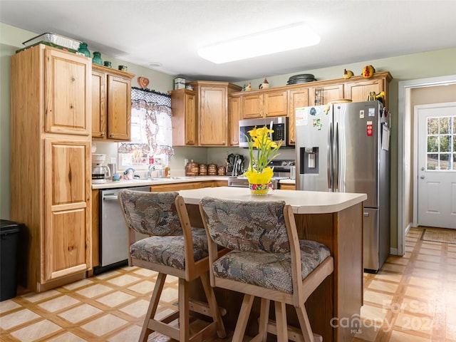 kitchen featuring appliances with stainless steel finishes, light tile floors, and sink